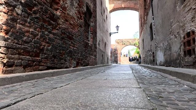 Narrow street in old town. A walk through the historic streets in the center of the old town. Old historic street. Torun, Poland.