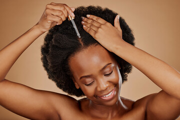 Oil serum, hair care or black woman with afro in studio on brown background for a healthy scalp....