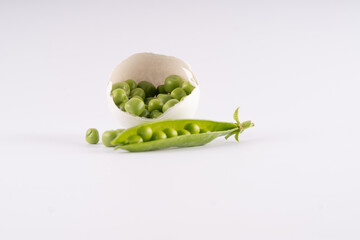 
a green pea lies in an eggshell, waste-free production. Conceptual serving of food