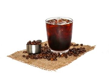 Americano ice coffee and coffee beans spread on the sack in white background.concept isolate picture.