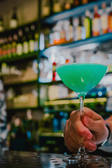 man hand bartender making cocktail in glass on the bar counter