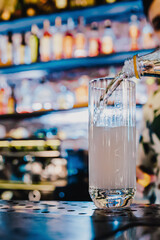 man hand bartender making cocktail in glass on the bar counter