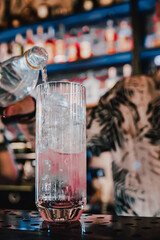 man hand bartender making cocktail in glass on the bar counter