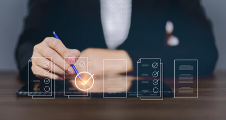 Check mark symbol represents the standard quality control. Businessman writing virtual glowing...