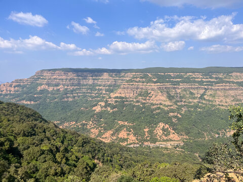 A large mountain of Deccan plateau and valley under a cloudy sky