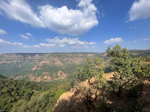 A large mountain of Deccan plateau and valley under a cloudy sky