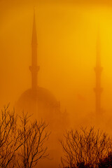 mosque with foggy, orange sunlight