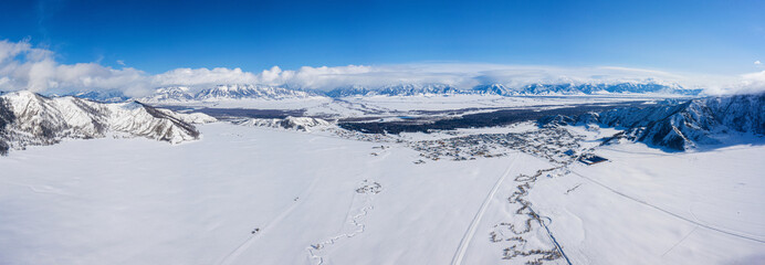 Fototapeta na wymiar Altai mountains in winter: Terektinsky Ridge and Verkh-Uymon village. Aerial view.