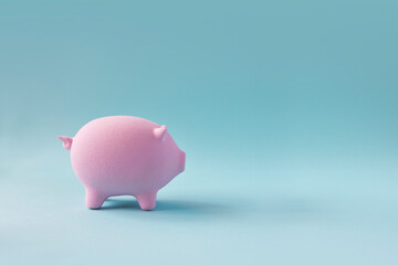 One piggybank on blue copy space background still life.