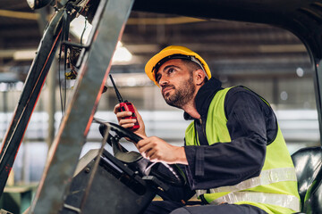Man worker at forklift driver happy working in industry factory logistic ship. Man forklift driver...
