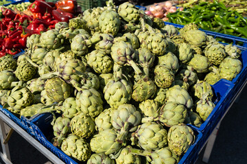 Artichoke in boxes at the bazaar close-up.