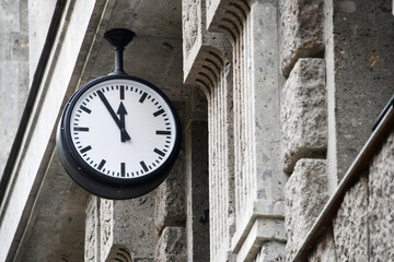 Berlin, Germany - June 6, 2023: clock shows five minutes to twelve