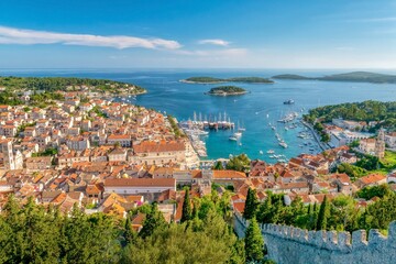 High angle view of the popular tourist resort town and island of Hvar, Croatia, viewed from the hillside stone wall of its 13th century fortress.
