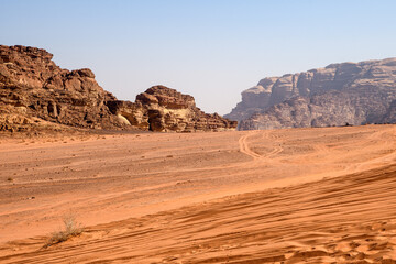 Fototapeta premium Arabian desert. Wadi Rum. Space landscape. Footprints in the sand. Filming location for many science fiction films.