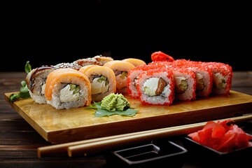 Appetizing sushi rolls in assortment. Soy sauce, ginger