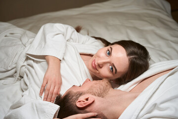 Obraz na płótnie Canvas Serene female resting with man in bedroom