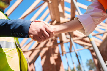 Contractor and building engineer shaking hands, close-up