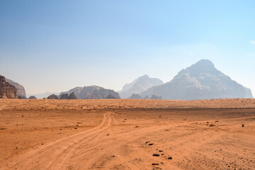 Arabian desert. Wadi Rum. Space landscape. Footprints in the sand. Filming location for many science fiction films. - obrazy, fototapety, plakaty