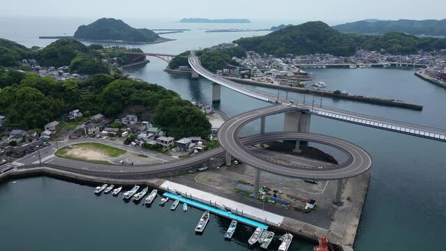 Ushibuka, Japan: Aerial view of the Haiya Bridge in the Amakusa island in kyushu in Japan on a overcast spring cold day. Shot with a tilt up motion