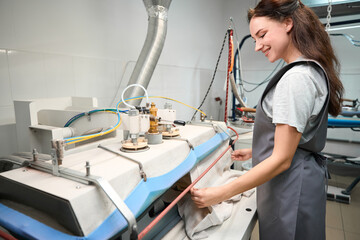 Laundry service worker using steam press for shaped-fixing and ironing process
