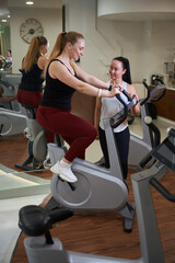 Fitness trainer conducts a workout for client of fitness clinic