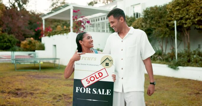 Property, real estate and a homeowner couple with a sold sign in the garden of their new house together. Love, mortgage or investment with a married man and woman in the yard for home ownership
