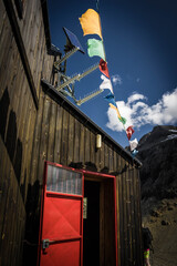 tibetan flags outside nacamuli hut in aosta valley