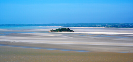 Fototapeta na wymiar landscape with the island Tombelaine in the bay of Mont Saint-Michel in the normandy at low tide, France