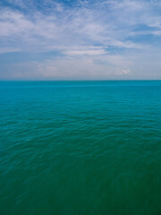 Obraz premium Vertical view Blue sea blue background look calm landscape viewpoint summer Nature tropical sea Beautiful ocean water Bangsaen Beach East thailand Chonburi Exotic horizon.