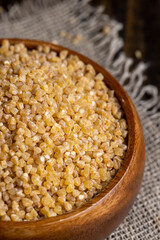 Fresh wheat porridge in a wooden bowl