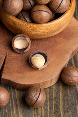 Unpeeled macadamia nuts on a wooden table