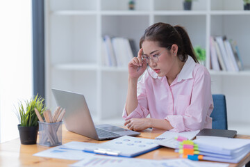 Sharing good business news. Attractive young businesswoman talking on the mobile phone and smiling while sitting at her working place in office.