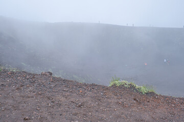 Fototapeta na wymiar Etna volcanic landscape in Sicily, Italy, view of a crater in fog