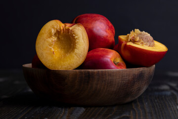 Nectarines folded in a wooden bowl