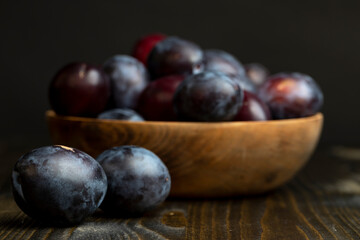 Ripe plums on the table in the kitchen