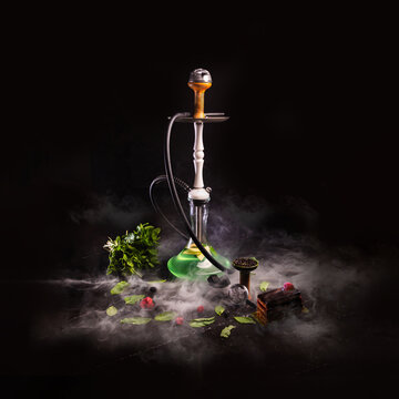 Kalyan. Citrus mix. Next to it is a leaf and a slice of orange and lemon. with smoke.