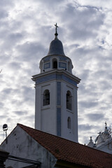 Cloudy sky and church towe