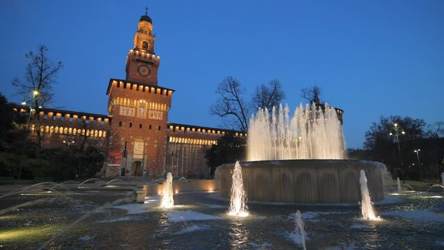 Sforzesco Castle and fountain in Milan, Italy at twilight.