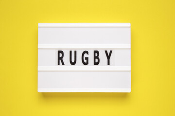 The word rugby on lightbox isolated yellow background.