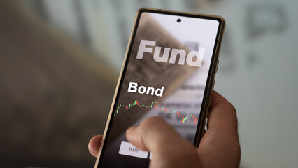 Exchange-traded fund chart, invest in stock market data on smartphone of bonds. Business analysis of a trend. Investing in international funds. Buying blue chips bond strategic ETF. To invest in ETFs