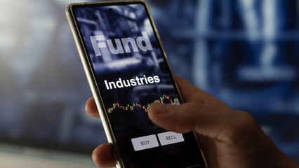 An investor's analyzing the industrials etf fund on a screen. A phone shows the prices of Industrials fund. To invest in ETFs