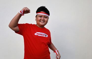 Indonesian boy celebrate Indonesia independence day with red white attribute