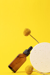 Cosmetic bottle with serum with floral extracts craspedia flowers. Skin care cosmetic. Hyaluronic acid oil, serum with collagen and peptides.