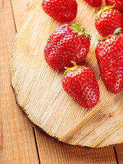 Fresh red strawberry on wooden stand. Ripe delicious strawberries on wooden boards. Close up