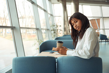 Brunette woman posing at camera in modern room