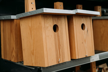Buying a wooden nesting box for the birds in the garden. Bird houses for sale in the store