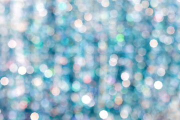 Background shot on a 50 millimeter lens with 8 flatterers of glittery tinsel out of focus in...