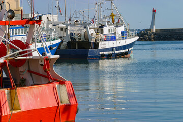 Lovely colorful fishing boats in artisanal small fishing harbor. 