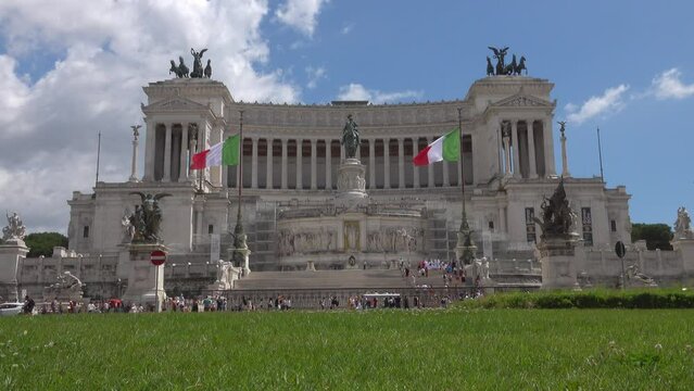 The Vittorio Emanuele II National Monument of Rome, Italy is shown during a partly cloudy day. The structure was built between 1885-1935 to honor the first king of unified Italy.