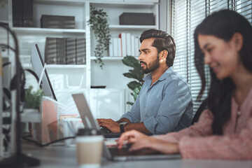 Young serious indian professional business man working with computer at home office, businessman at work in casual clothes.
